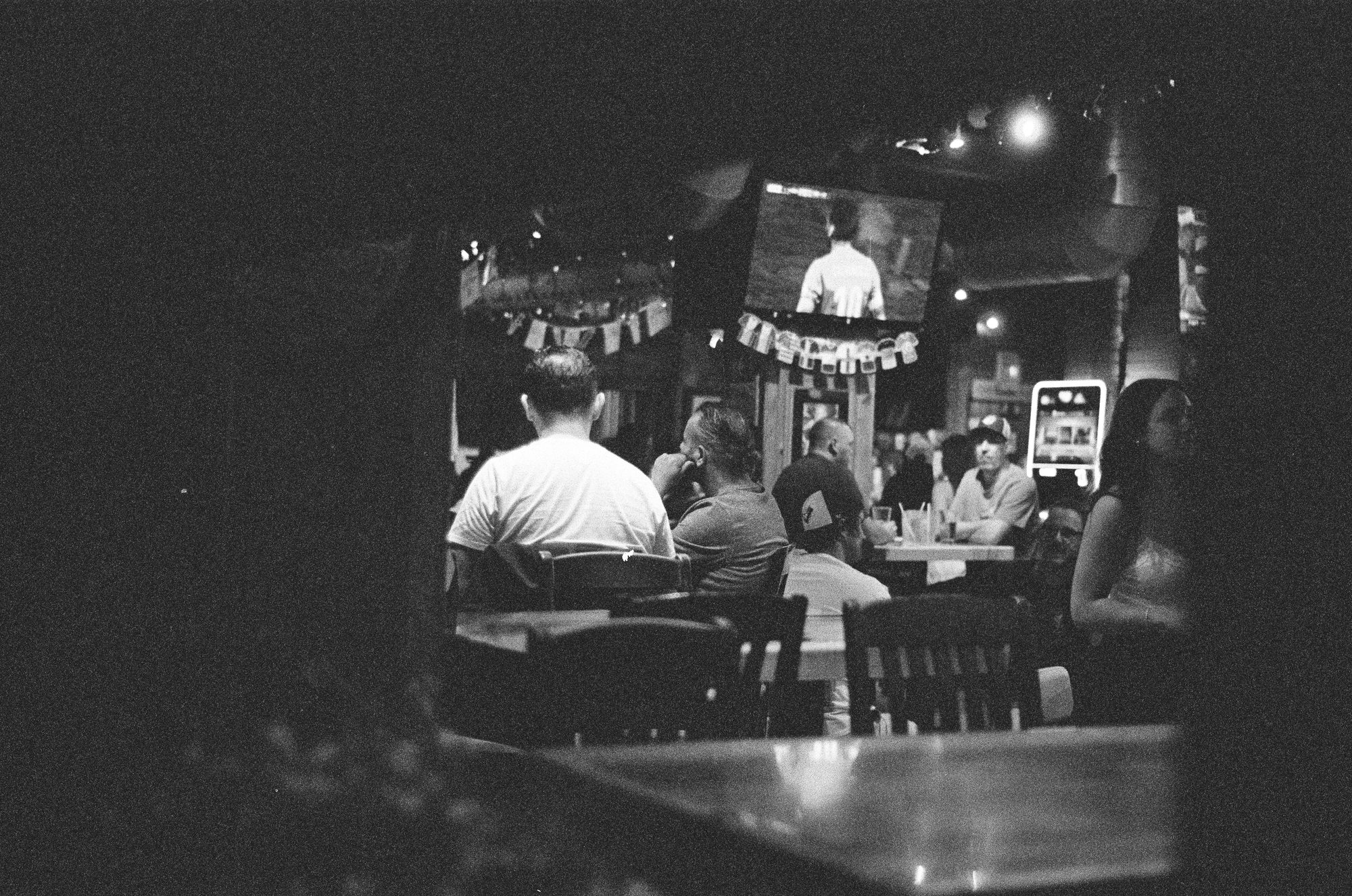 A bar interior glowing beyond a dark foreground