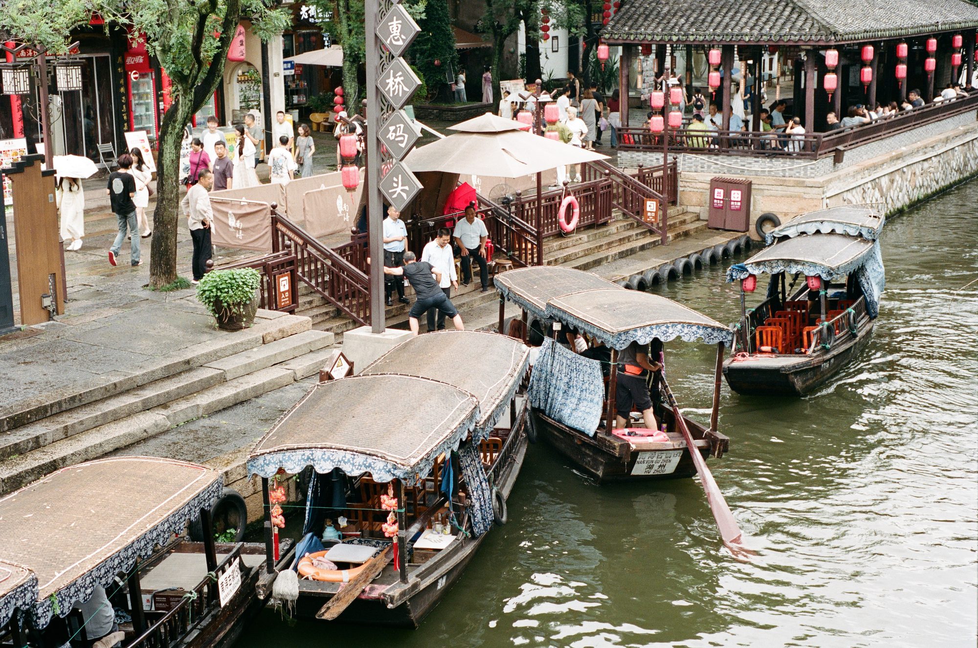 Tour boats moored by stone steps on a canal