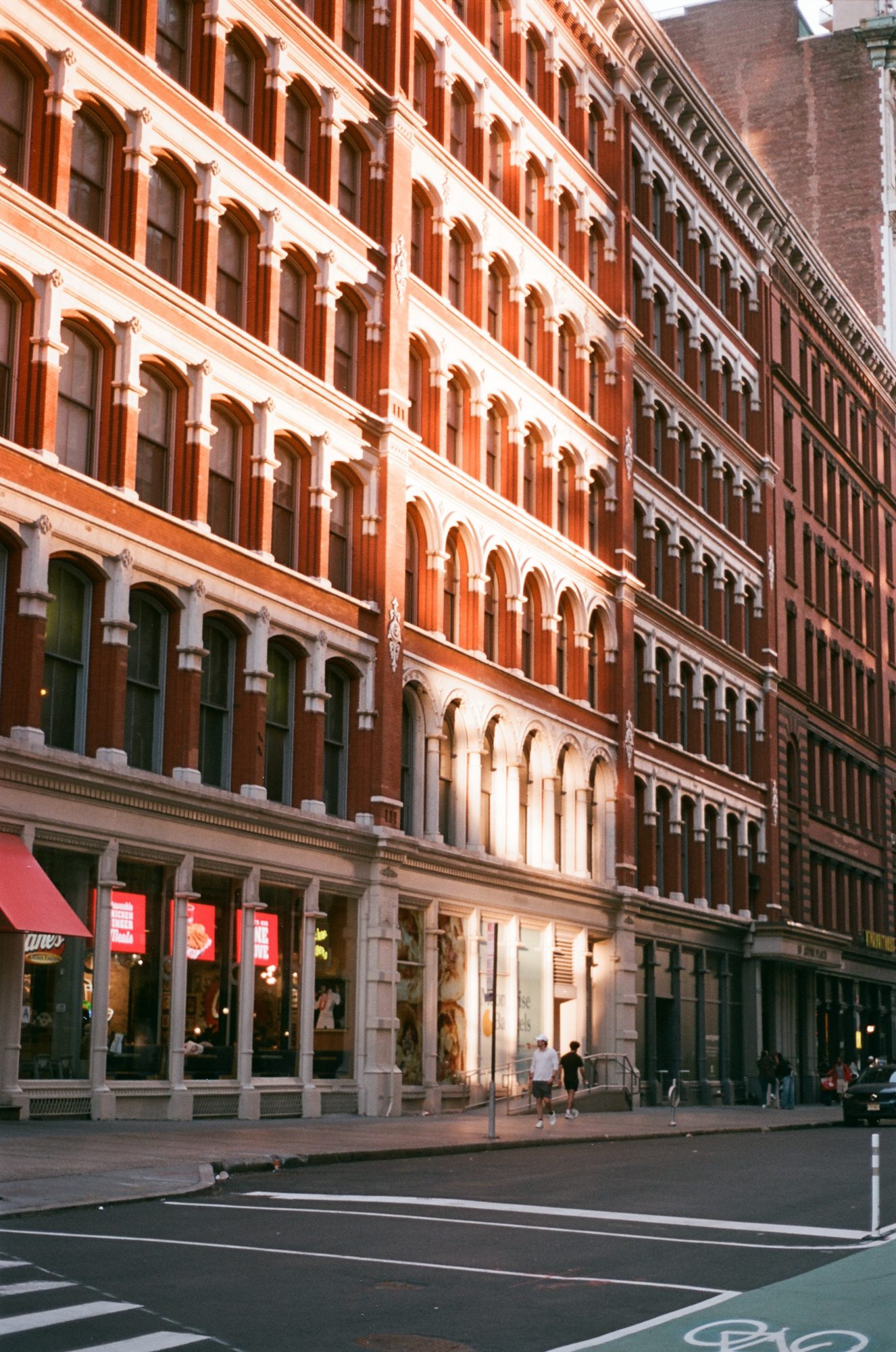 Red-brick cast-iron buildings lit warm by the low sun