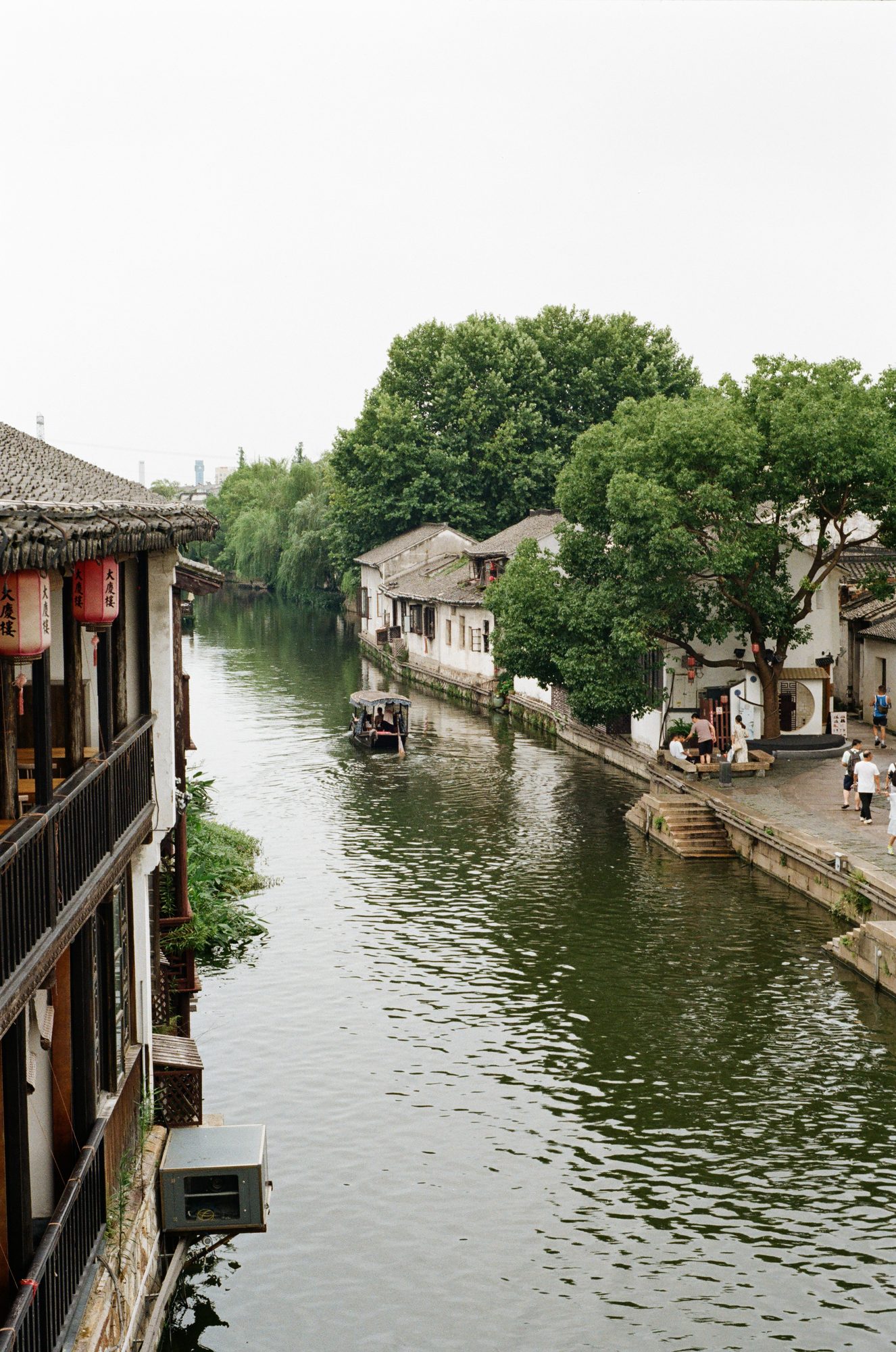 A canal lined with old houses and trees