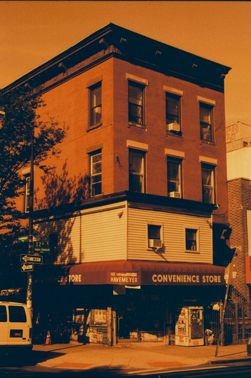A three-storey corner building above a convenience store