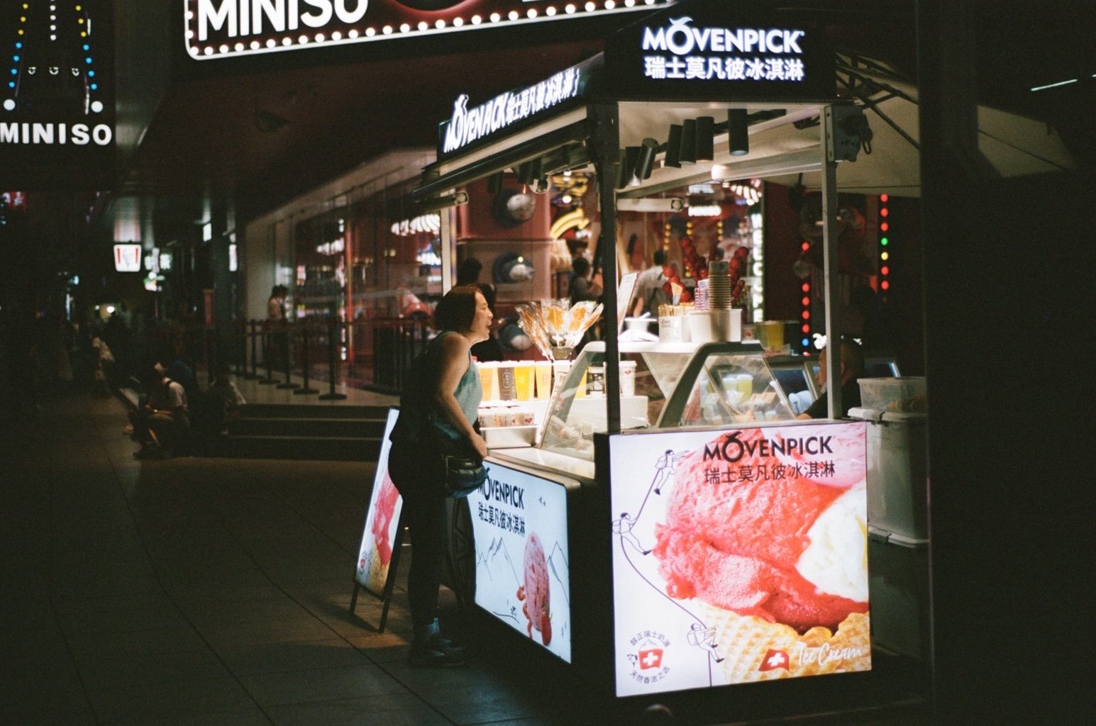 Shop windows glowing on a night street